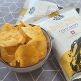 A bowl of Made For Drink's Baron Bigod Cheese & Onion Crisps with 2 x 40g packs in the background.