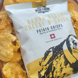 A 40g pack of Made For Drink's Baron Bigod Cheese & Onion potato crisps lying on a bed of scattered crisps.