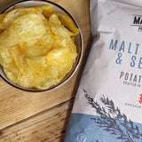 A bowl of Made For Drink's Malt Vinegar &  Sea Salt flavoured English Heritage potato crisps with a 150g pack in the background. 