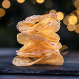 A stack of Made For Drink's English Heritage potato crisps on a slate serving board.